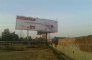 Hoarding facing NH 24 from Indirapuram  Side red light crossing
